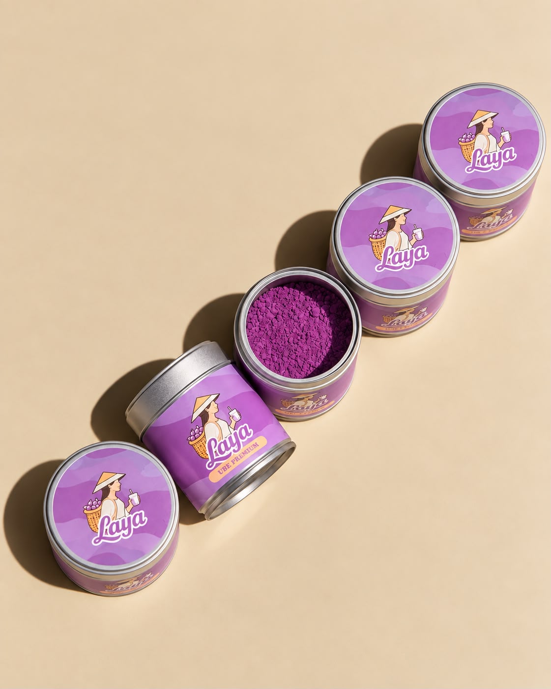 Quatre pots d'Ube Laya, l'un ouvert laissant voir la poudre violette
