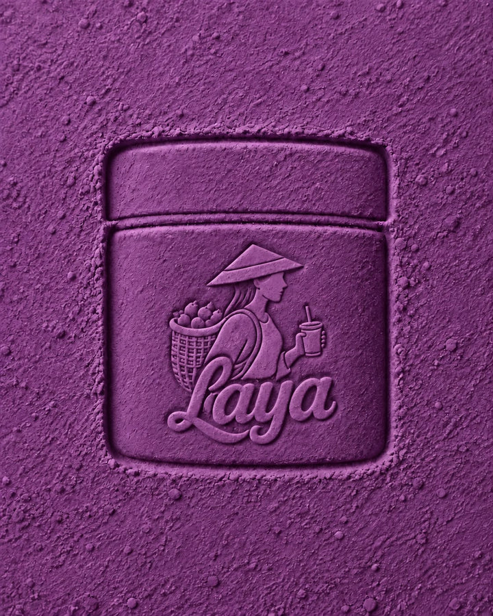 Close-up of purple ube powder with the Laya logo embossed